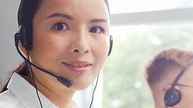 Diverse team of young professionals is working in the phone support office. Working day of sales managers in the call