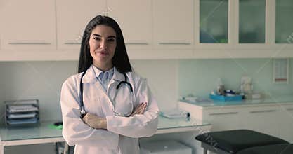 Happy Latina general practitioner, nurse or cardiologist posing in office