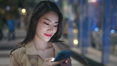 Joyful Woman Trans Posing on the Phone Camera on Night City Lights Background.