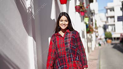 Smiling Woman Walking in Sunny Spanish Town