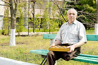 Senior amputee sitting on a park bench