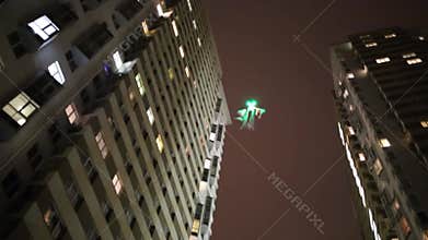 Flying illuminated helicopter ghost at night among