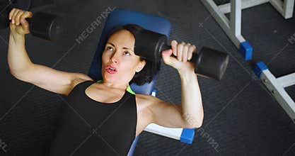 Top view of a middle aged fit Caucasian woman during gym workout.
