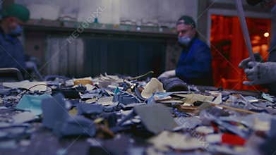 Man sorts garbage, electronics or plastic. Waste recycling plant or garbage factory. Conveyor belt