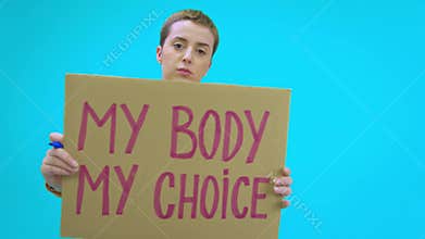 Protester holding signs my body my choice, abortion is healthcare and bans off our bodies.