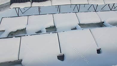 Snowbound solar batteries at winter day. Aerial