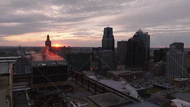 Sunrise over Kansas city downtown. Sunlight highlights skyscrapers and industrial buildings, creating striking