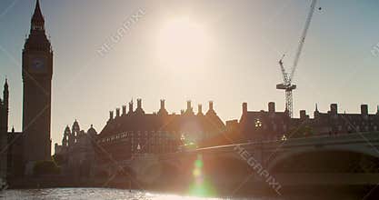 People and red buses crossing Westminster Bridge by Big Ben and the Houses of Parliament, London, England