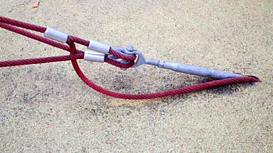 Steel anchor hooked into asphalt covering which