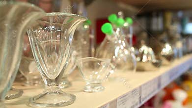 Glass and metal utensils on the shelf in the