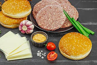 Burger patties. Beef cutlets, buns, vegetables and sauce. Homemade American classic