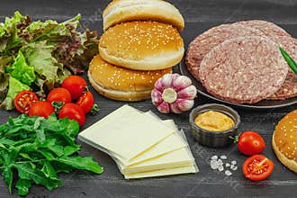 Burger patties. Beef cutlets, buns, vegetables and sauce. Homemade American classic