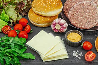 Burger patties. Beef cutlets, buns, vegetables and sauce. Homemade American classic