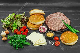 Burger patties. Beef cutlets, buns, vegetables and sauce. Homemade American classic