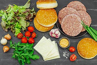 Burger patties. Beef cutlets, buns, vegetables and sauce. Homemade American classic