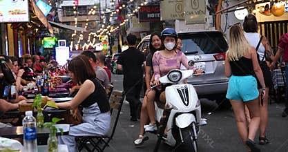 Vietnam Ho Chi Minh City 06.03.2024 Saigon evening people People walk around the city, sit in cafes, ride motorcycles
