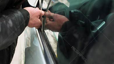 Man in leather jacket tries to break door lock of