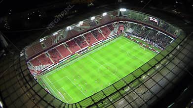 Football teams play on field during match of UEFA