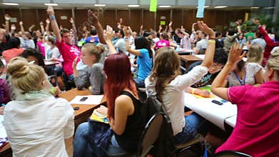 Many young people raise their hands up at the