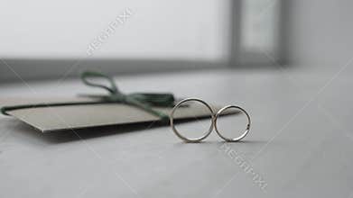 Wedding rings roll towards each other