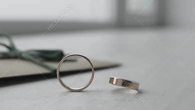 The wedding ring is spinning on the table