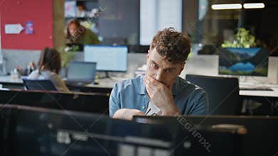 Overworked manager staring desktop working open space closeup. Tired freelancer