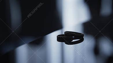 Wedding rings on a mirror in backlight