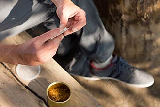 Man rolling a cannabis joint