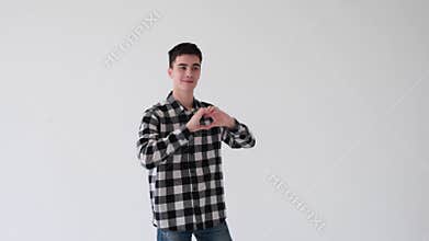 Playful Man In Love Showing Heart Shape Gesture On White Background