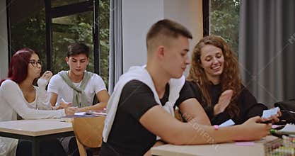 High school students collaborate on school projects during class with their professors guidance.