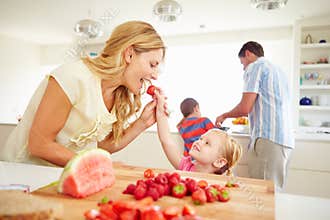 Daughter Helping Mother To Prepare Family Breakfast