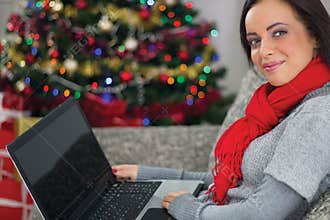 Woman using laptop on Christmas night