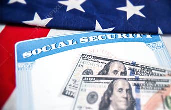 Social Security card is placed on the American flag, background. Social Security for old age people in USA concept backdrop