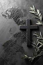 A cross and olive branch on a black surface