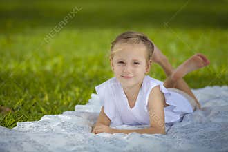 Girl Smiling on a White Blanket