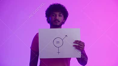 A serious african american guy activist with a direct and confident gaze shows a poster with male and female symbols