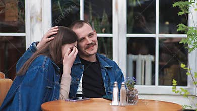 Young couple Denim clothes date in a vintage restaurant, outside They are talking Fooling around