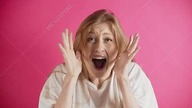 Oh my god wow. Amazed excited young woman raising hands in surprise looking at camera with big eyes, shocked by sudden