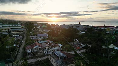Buildings of city by sea overlooking sunset in warm season