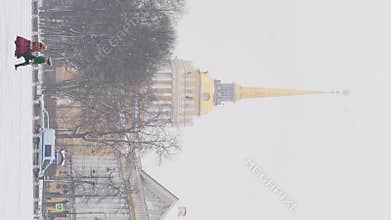 Russia, Saint Petersburg, 30 December 2023 - The golden spire of the Admiralty building through vintage lampposts at the