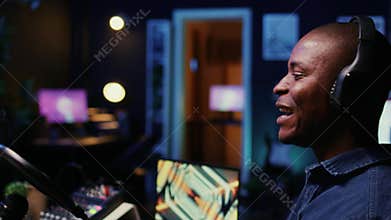 Man doing podcasting session with professional streaming sound gear, panning shot