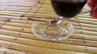Glass Cup of black coffee on wooden bamboo table Thailand