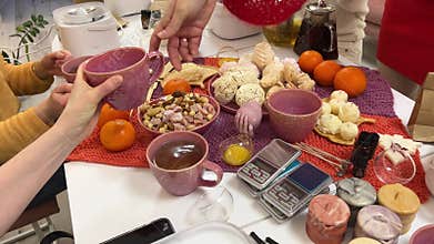 Bachelorette party women's tea party making massage candles drinking tea talking sitting at the table close-up