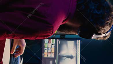 Vertical video Freelancer videographer finishing project in apartment studio