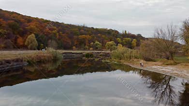 Autumn aerial flight above river water surface