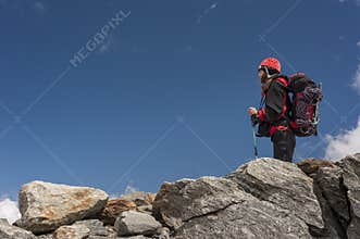 Woman mountaineer alone on rocks