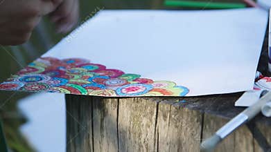 Boy with crayon draws colorful texture drawing