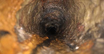inside old dirty and rusty cast iron sewer line pipe