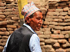 A Nepali old man wearing a traditional cap