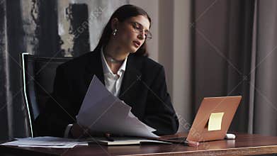 Young caucasian woman business worker angry reading documents throwing papers on air at the office. stress management
